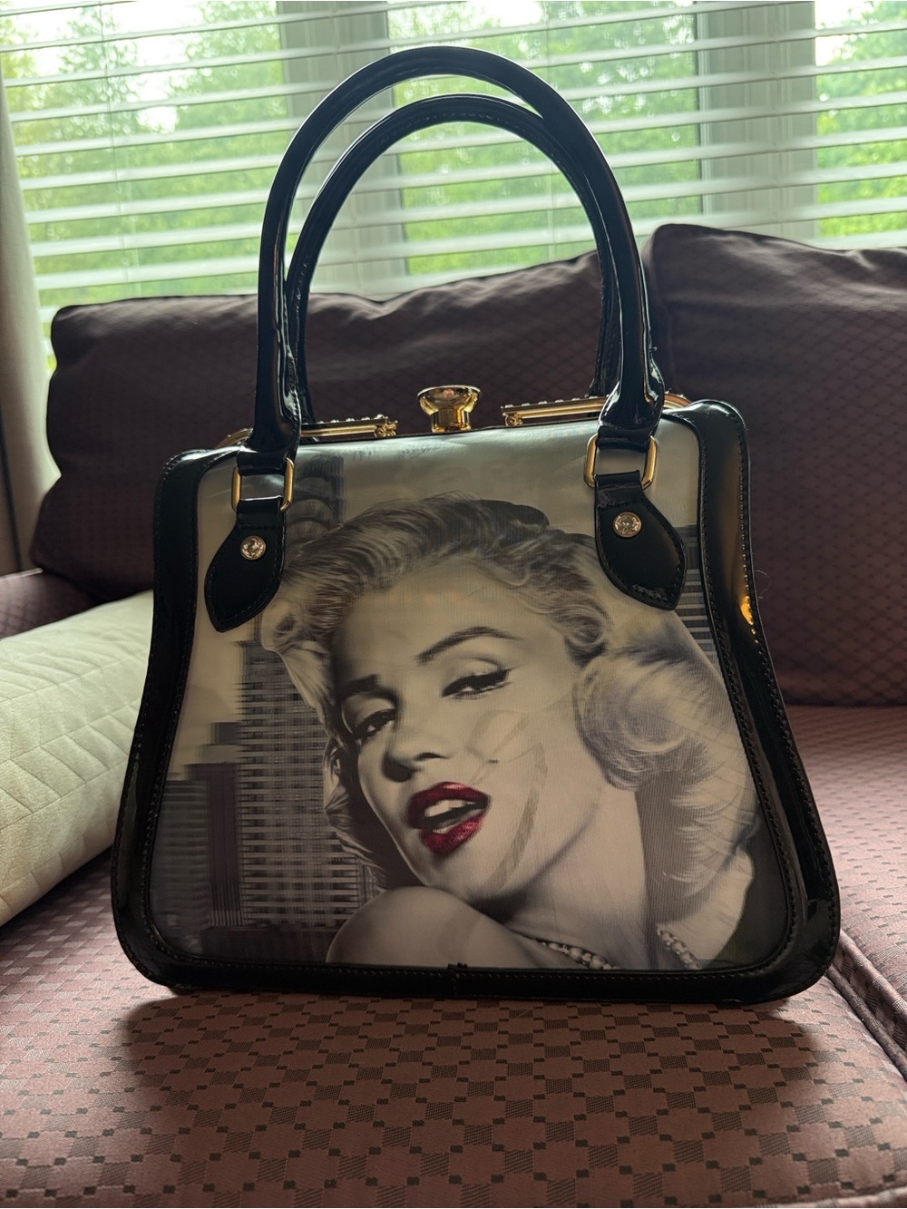 Classic Black Patent Handbag with Retro Portrait Detail